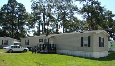 Well-maintained mobile home on green lawn